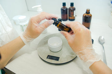 Hands measuring natural ingredients for Frankly Naturals products